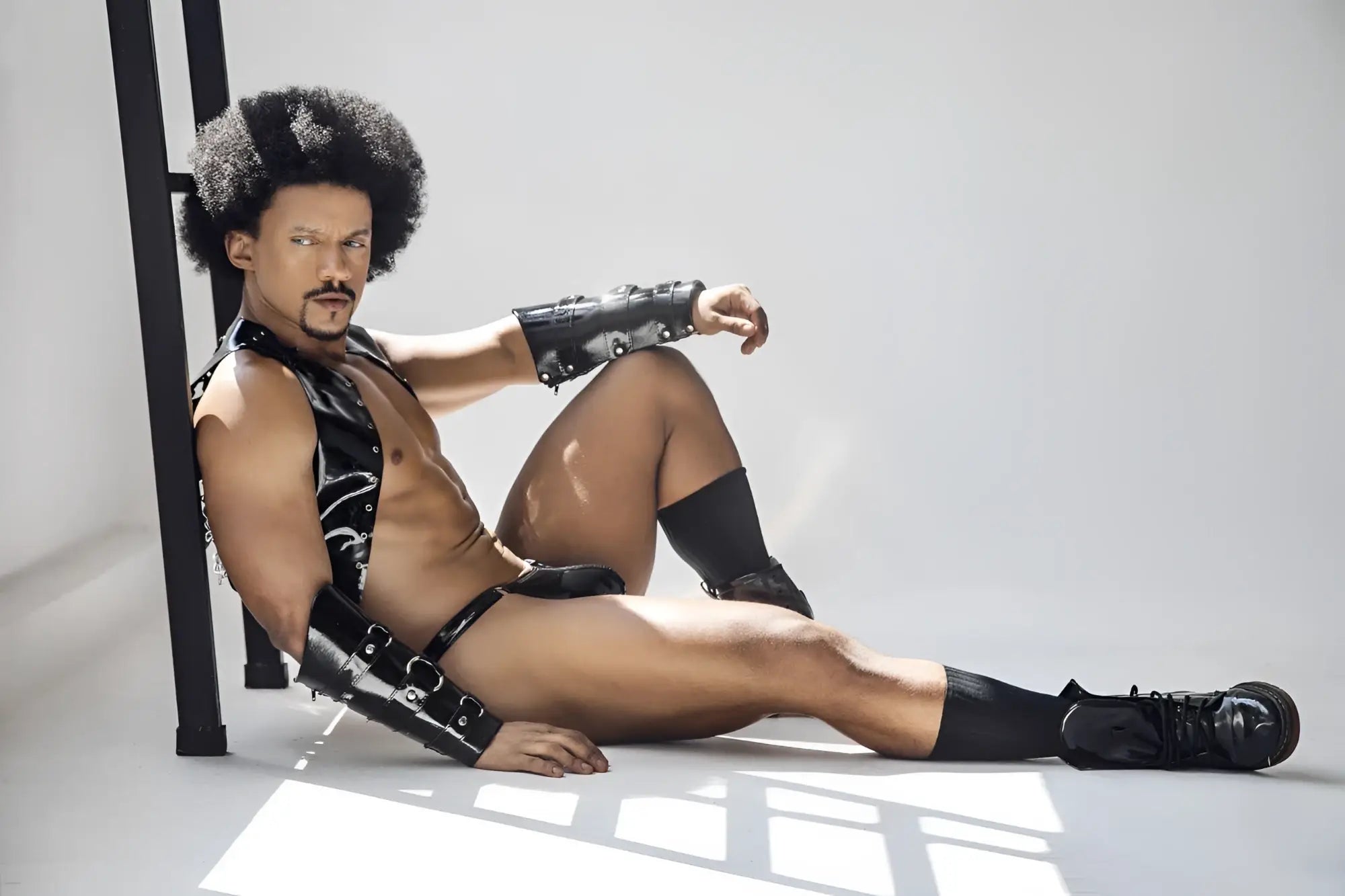 Black leather arm and leg bracers with silver hardware from Candyman 99819 Dom Thongs in gloss black color