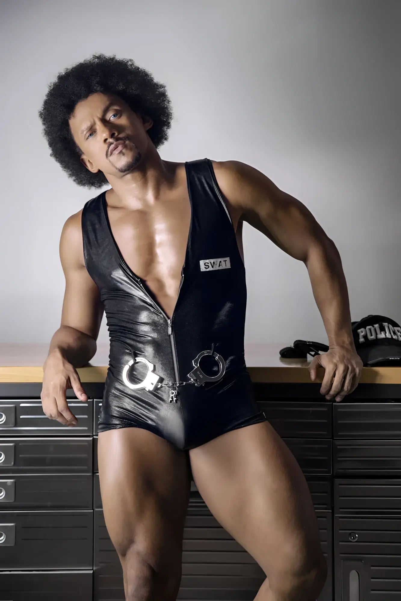 Black shiny vinyl swat bodysuit candy man 99844 with silver handcuffs attached at the waist for police costume