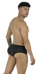 CandyMan black trunks featuring a low-rise, fitted design on a male model looking back over his shoulder.
