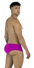 CandyMan magenta trunks, low-rise style with a form-fitting cut, worn by a man looking over his shoulder.