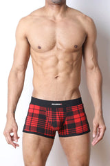 Male model wearing red and black plaid trunk underwear with black waistband featuring CellBlock 13 logo