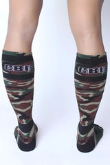 Camouflage-patterned knee-high socks with black ribbed cuff and white cbi logo from cellblock 13 foxhole series