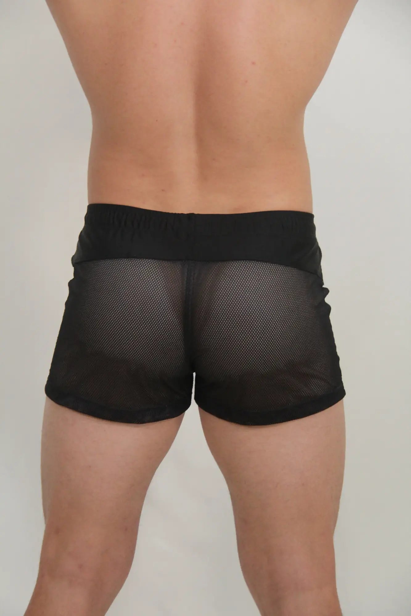 Black circuit mesh shorts with a solid black waistband made from breathable mesh material