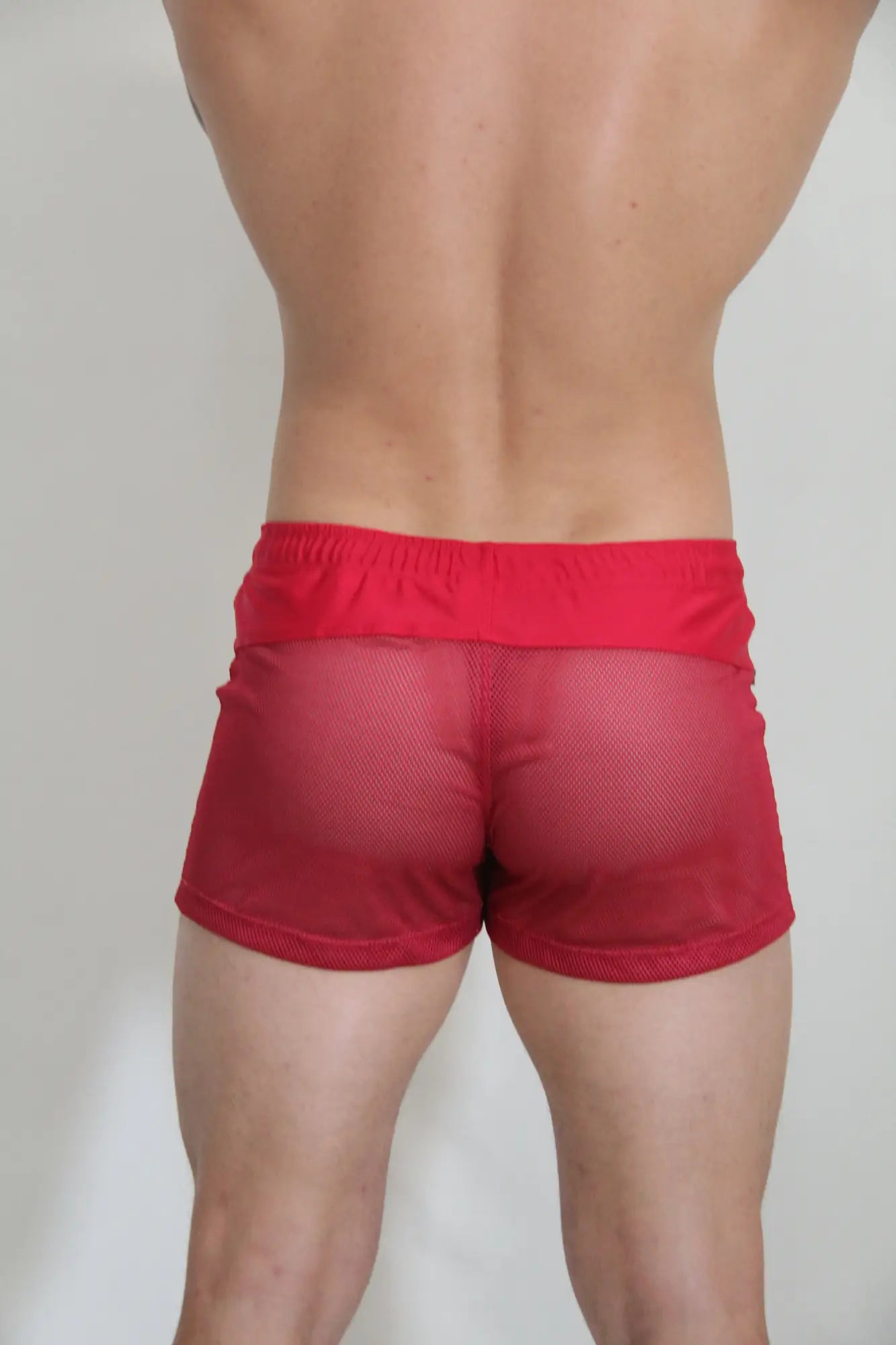 Red circuit mesh shorts with solid red elastic waistband made of breathable mesh material