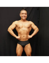 Black bodybuilding posing suit by Arroyman featuring a classic cut worn by a model showcasing physique.