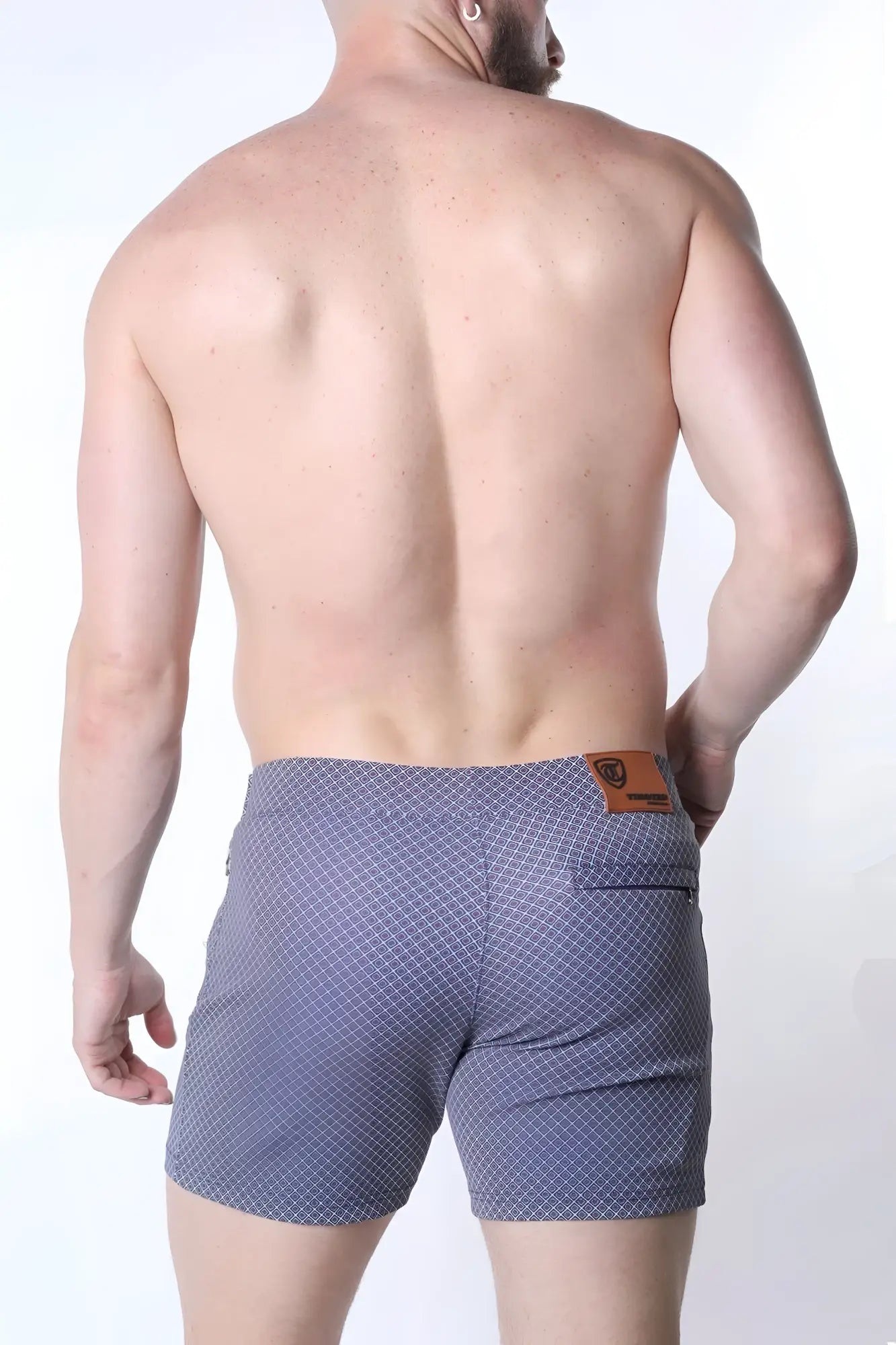 Clemente swim short limited edition blue patterned swim trunks with subtle geometric design and brown leather waistband patch