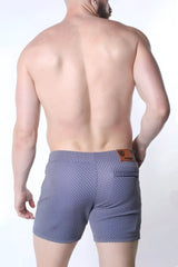 Clemente swim short limited edition blue patterned swim trunks with subtle geometric design and brown leather waistband patch