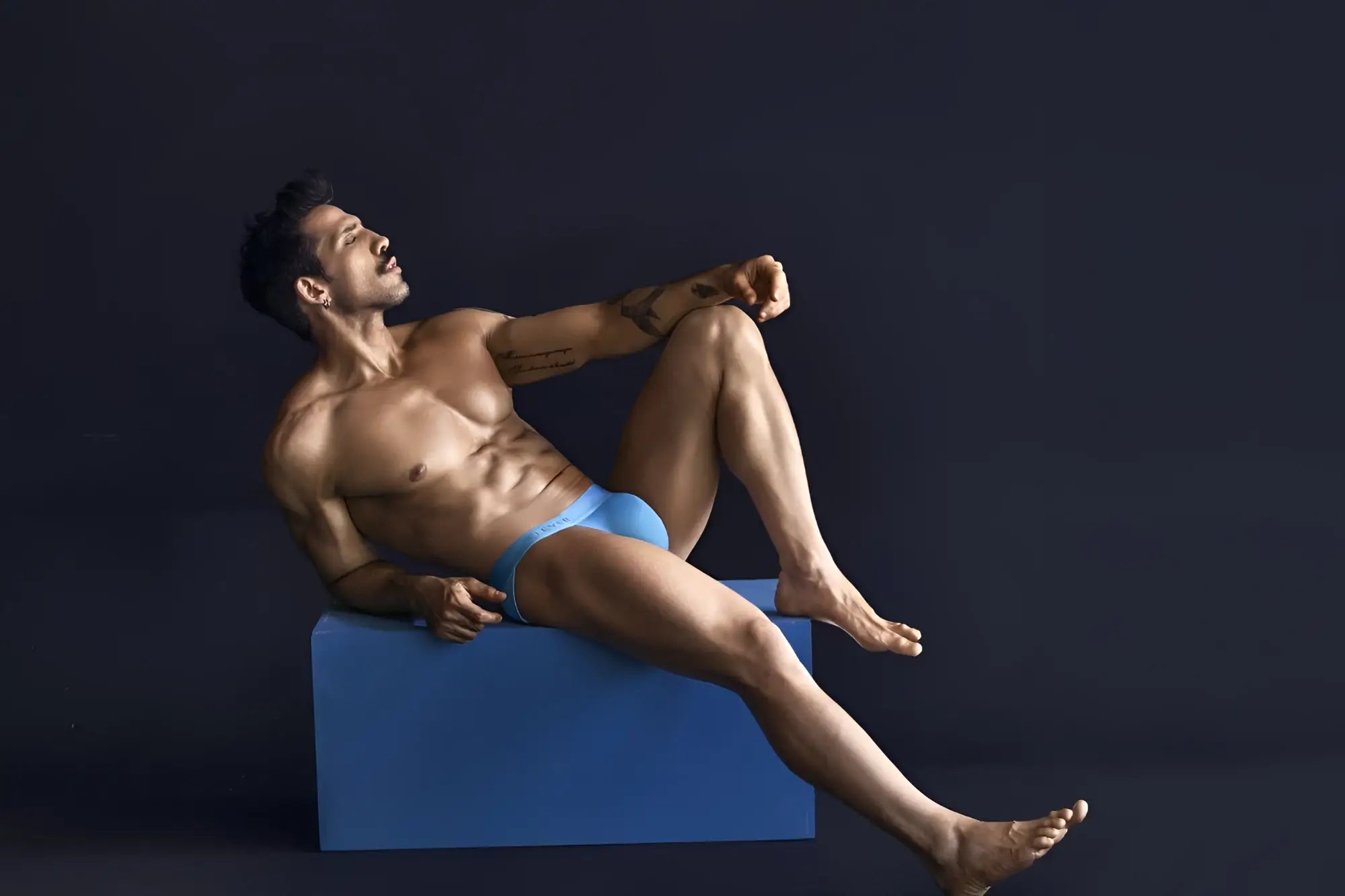 A man wearing bright blue Clever 1749 eco bikini briefs made from sustainable material front view