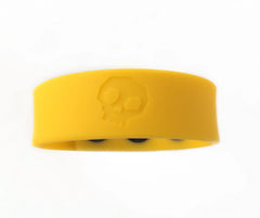 Bright yellow silicone cock strap wristband with subtle embossed skull design for edgy fashion statement