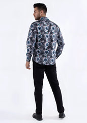 A man wearing a colored shapes print long-sleeved shirt with navy white and muted blue geometric floral pattern