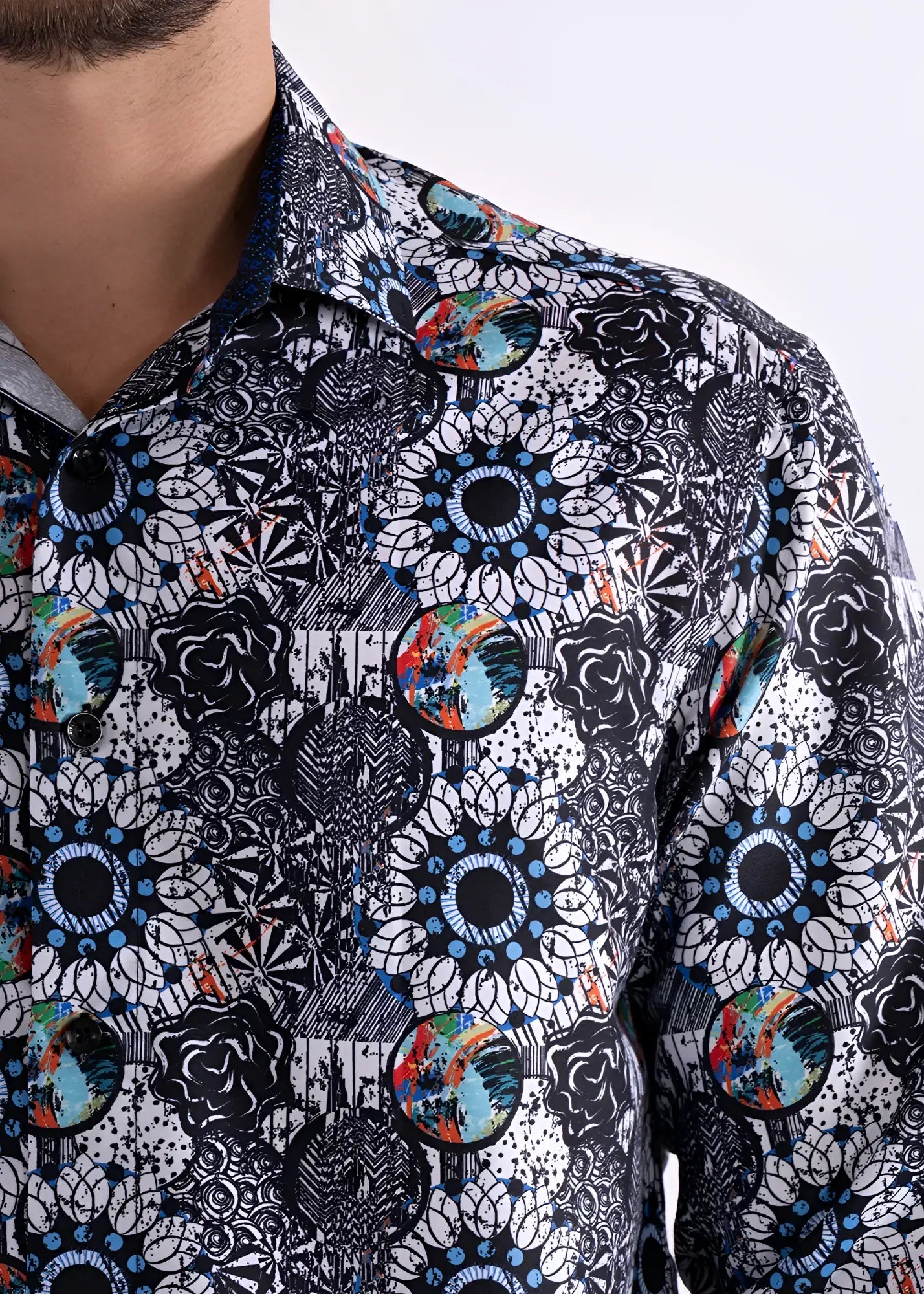 A men’s long sleeve button-up shirt with black and white floral pattern and colorful blue, green, orange, and red accents
