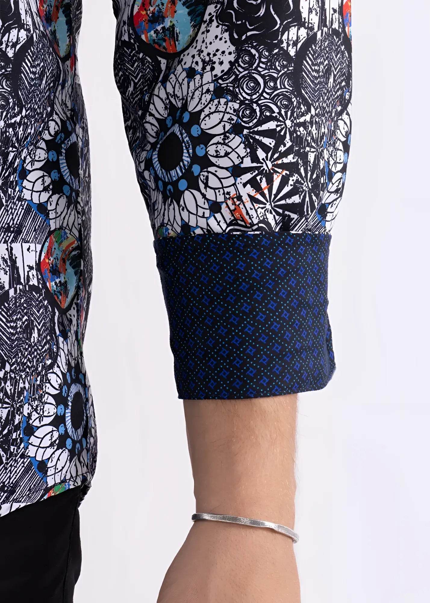 Colored shapes print long sleeve shirt with bold black white pattern, blue and orange splashes, and navy geometric cuff