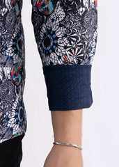 Colored shapes print long sleeve shirt with bold black white pattern, blue and orange splashes, and navy geometric cuff
