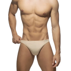 Beige cotton thong with a sleek minimalist design in athletic briefs style showing the back side of the product