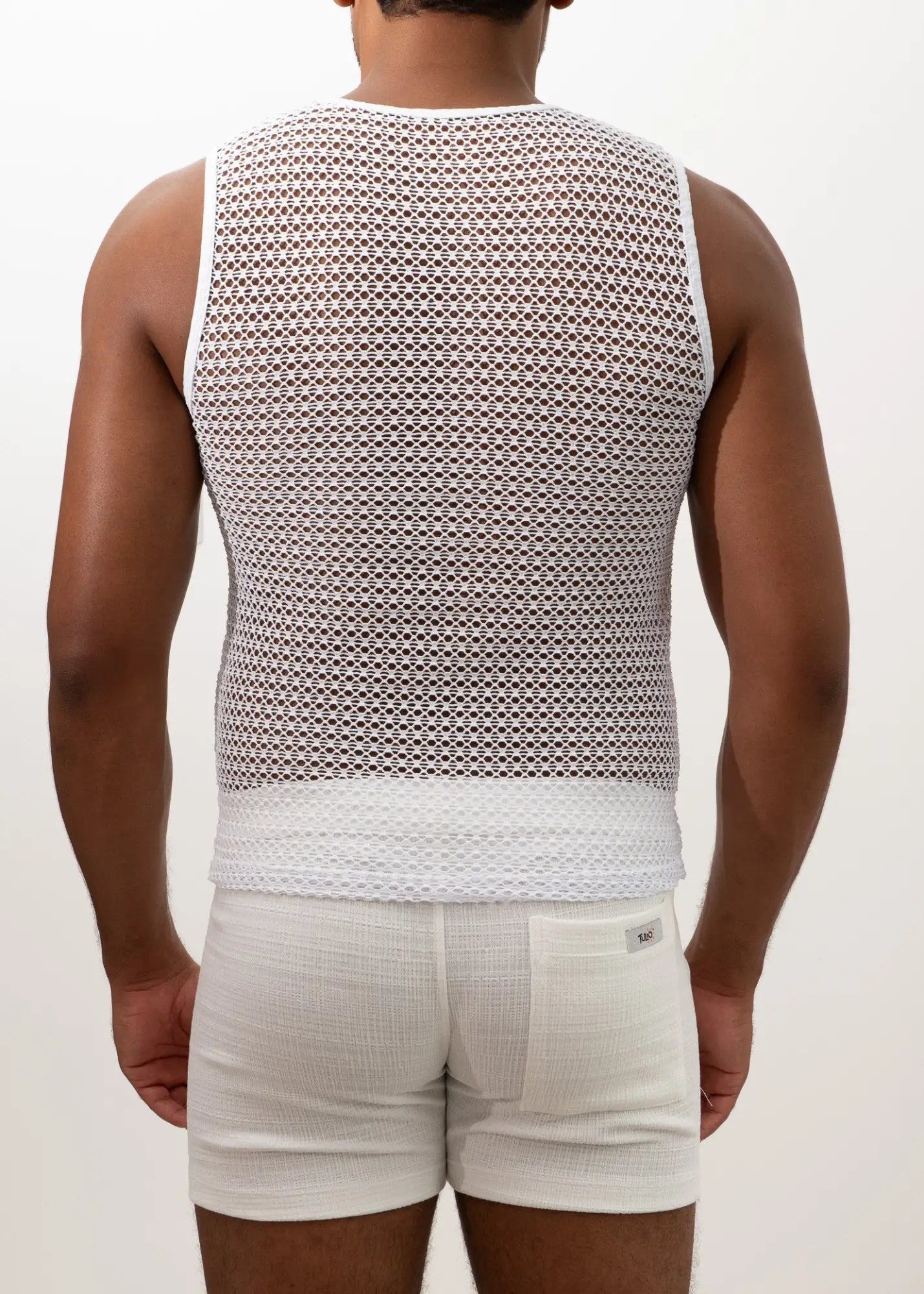 White crochet muscle tank top with mesh fabric and solid white band at the bottom front view
