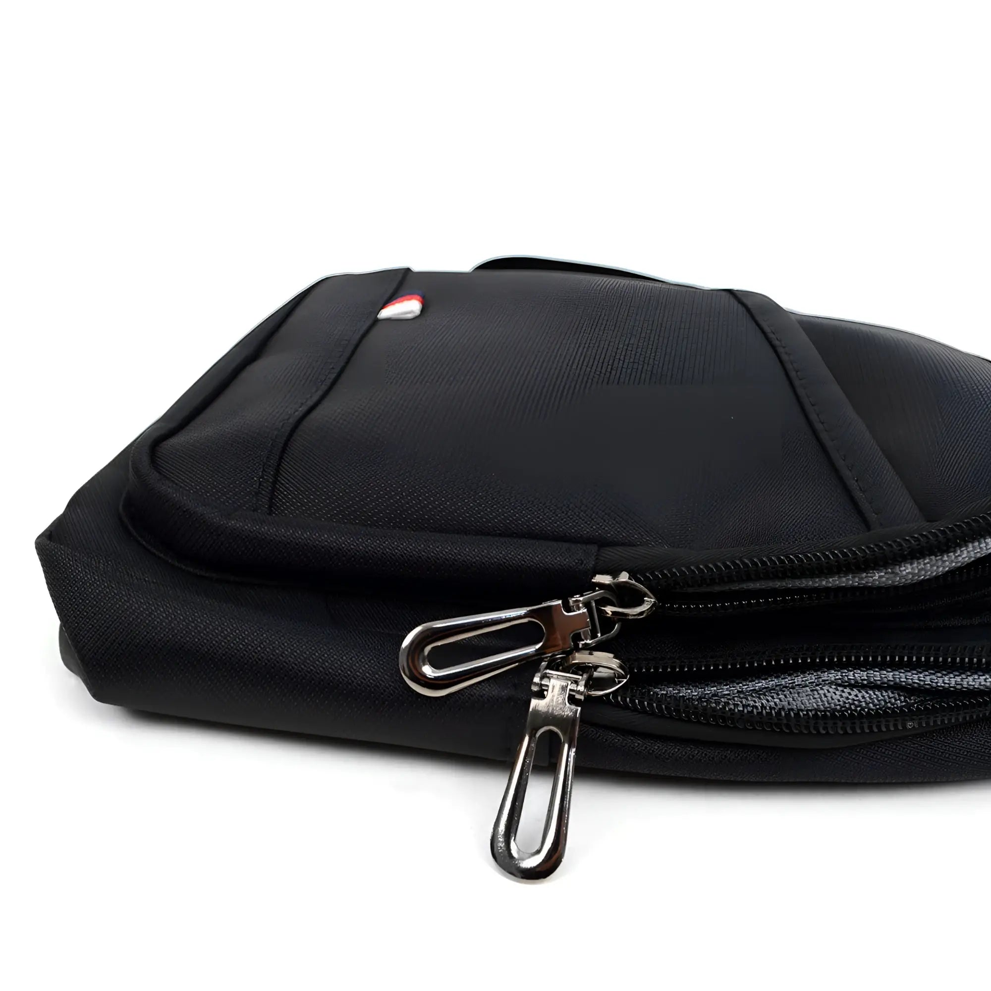 Black nylon crossbody sling bag with silver zipper pulls and small red white and blue logo on front
