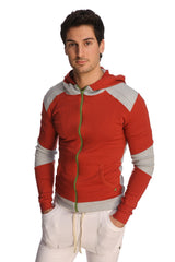 Form-fit crossover yoga track performance hoodie in cinnabar grey with red and gray panels, green zipper pull, and pockets