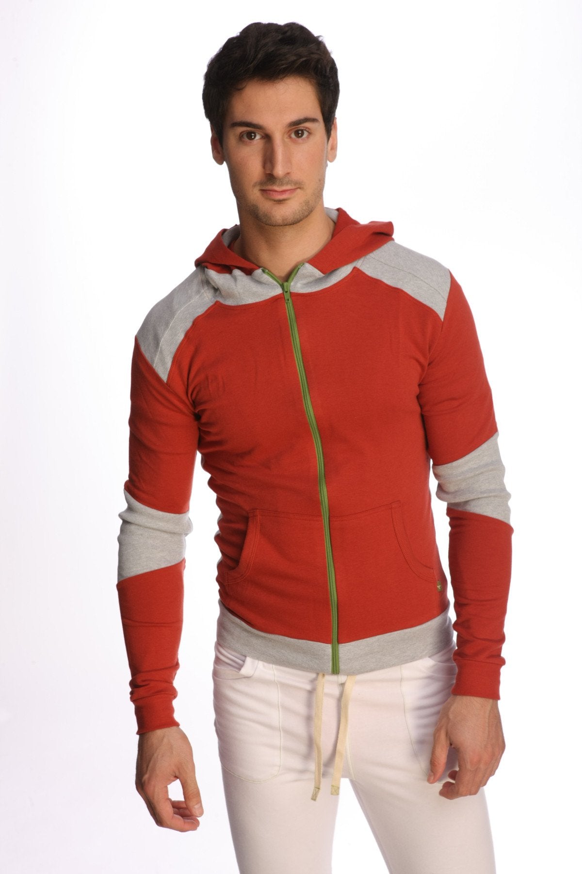 Form-fit crossover yoga track performance hoodie in cinnabar grey with red and gray zip-up design and green zipper
