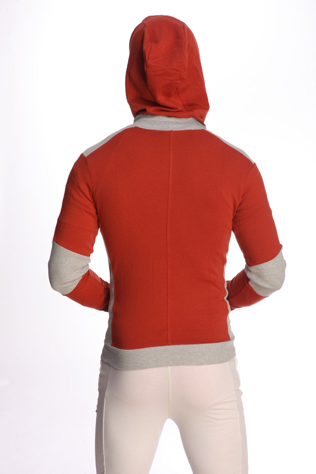 Form-fit crossover yoga track performance hoodie in cinnabar red with gray accents on shoulders sleeves and waistband