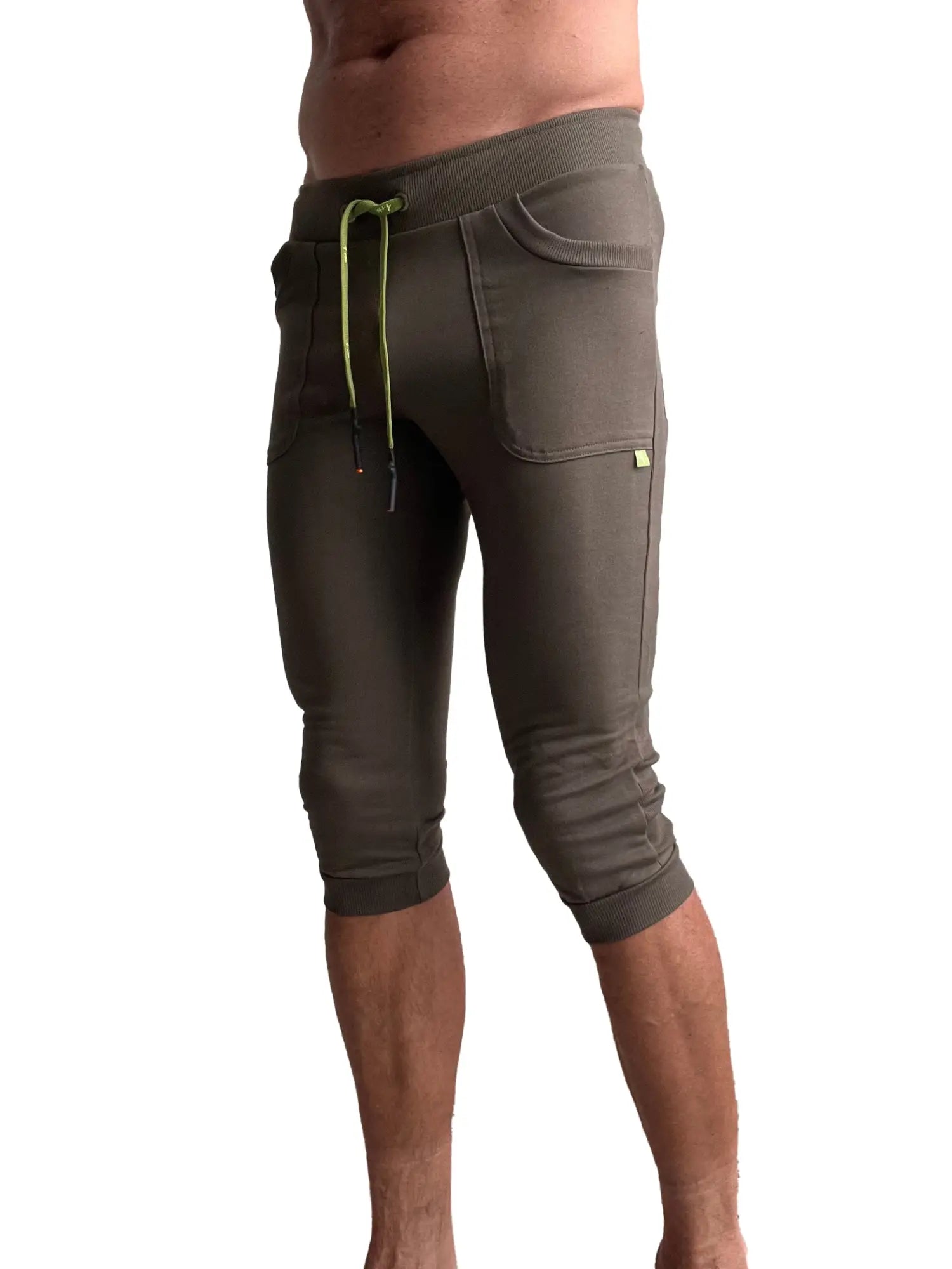 Cuffed yoga pants in army olive green with ribbed waistband and lime green drawstring for comfortable wear