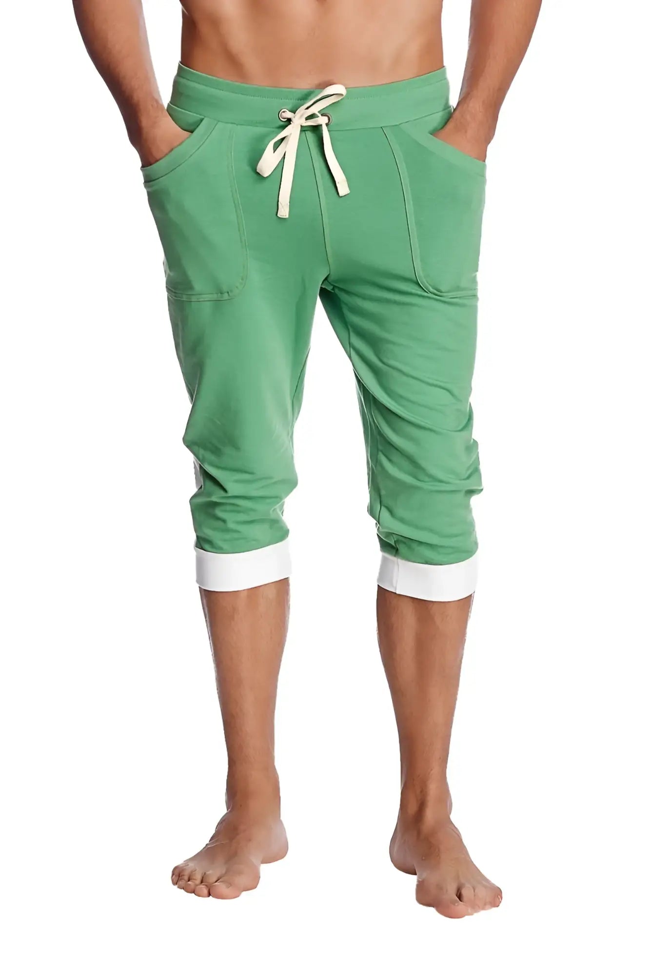 Green cuffed yoga pants made of bamboo fabric with white drawstring and contrasting white cuffs in capri length