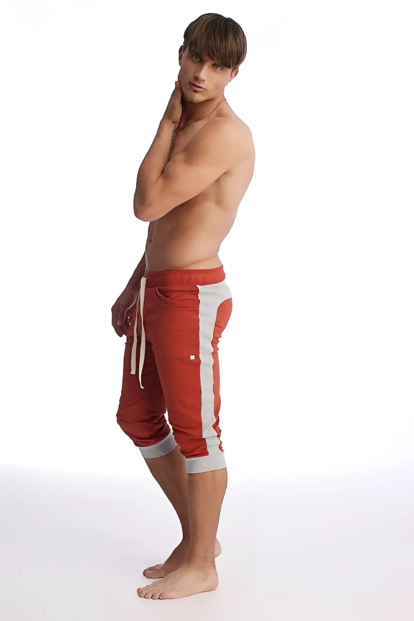 Cuffed yoga pants in cinnabar red and grey with a drawstring waistband and athletic capri style design