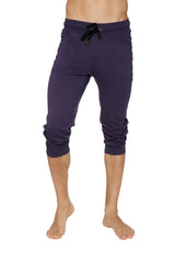 Navy blue capri-length cuffed yoga pants with black drawstring waistband and rolled cuffs for comfortable wear