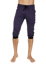 Dark purple capri-length cuffed yoga pants with black drawstring waistband and elastic cuffs for active wear