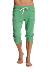 Green solid bamboo capri-length cuffed yoga pants with cream drawstring and side pockets for comfortable wear