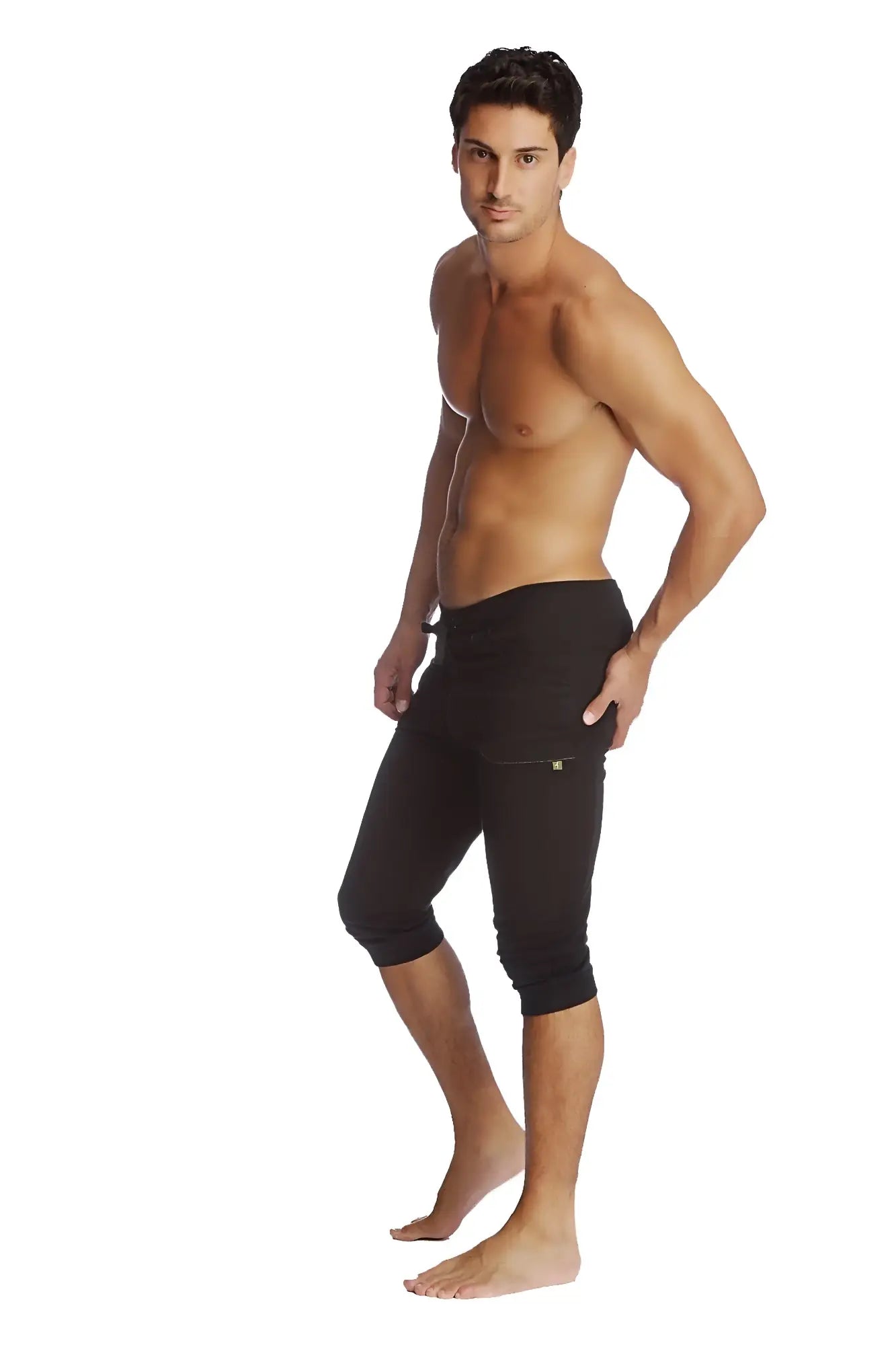 Black cuffed yoga pants with snug fit, subtle side pockets, and capri-length design for athletic wear