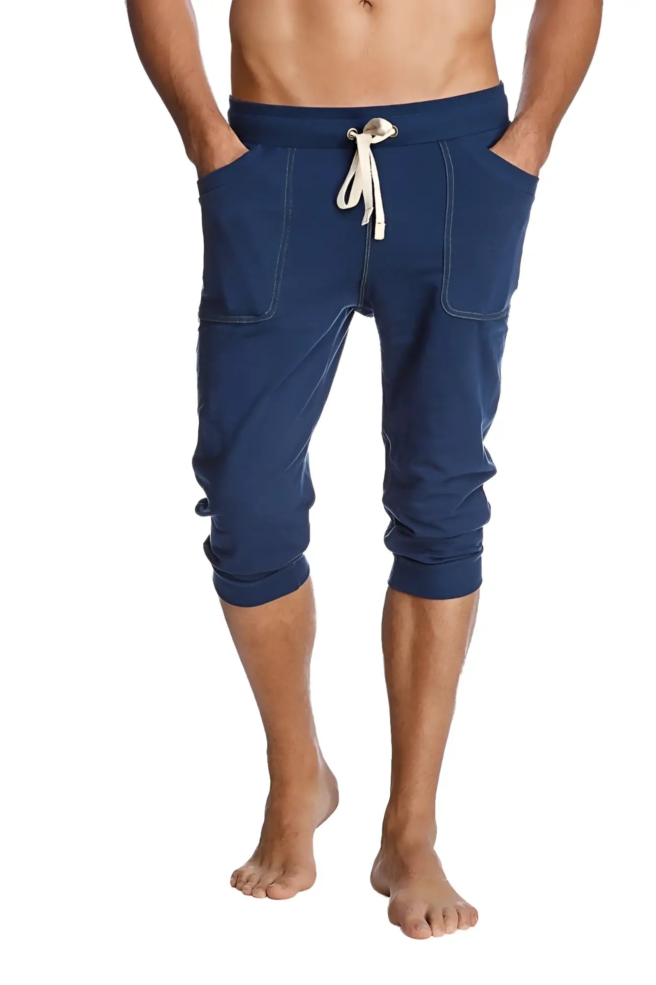 Navy blue cuffed yoga pants with white drawstring side pockets and capri-length jogger style for activewear