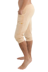 Beige cuffed yoga pants in solid sand with side pockets and subtle yellow zipper detail for comfortable wear