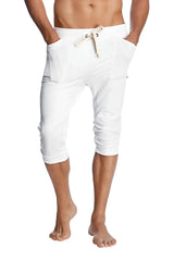 White cuffed yoga pants with capri-length jogger style drawstring waistband and side pockets for comfortable wear