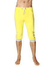 Bright yellow cuffed yoga pants with white drawstring and gray elastic cuffs in capri length for activewear