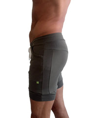 Dark gray cuffed yoga shorts with ribbed side panels and white drawstring for athletic and casual wear