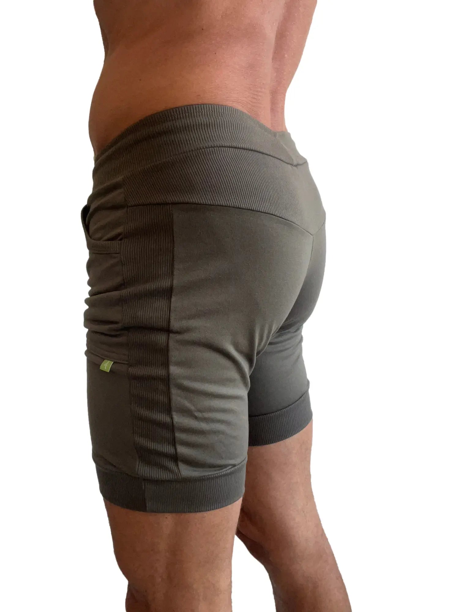 Olive green cuffed yoga shorts with ribbed side panels and elastic waistband for athletic wear