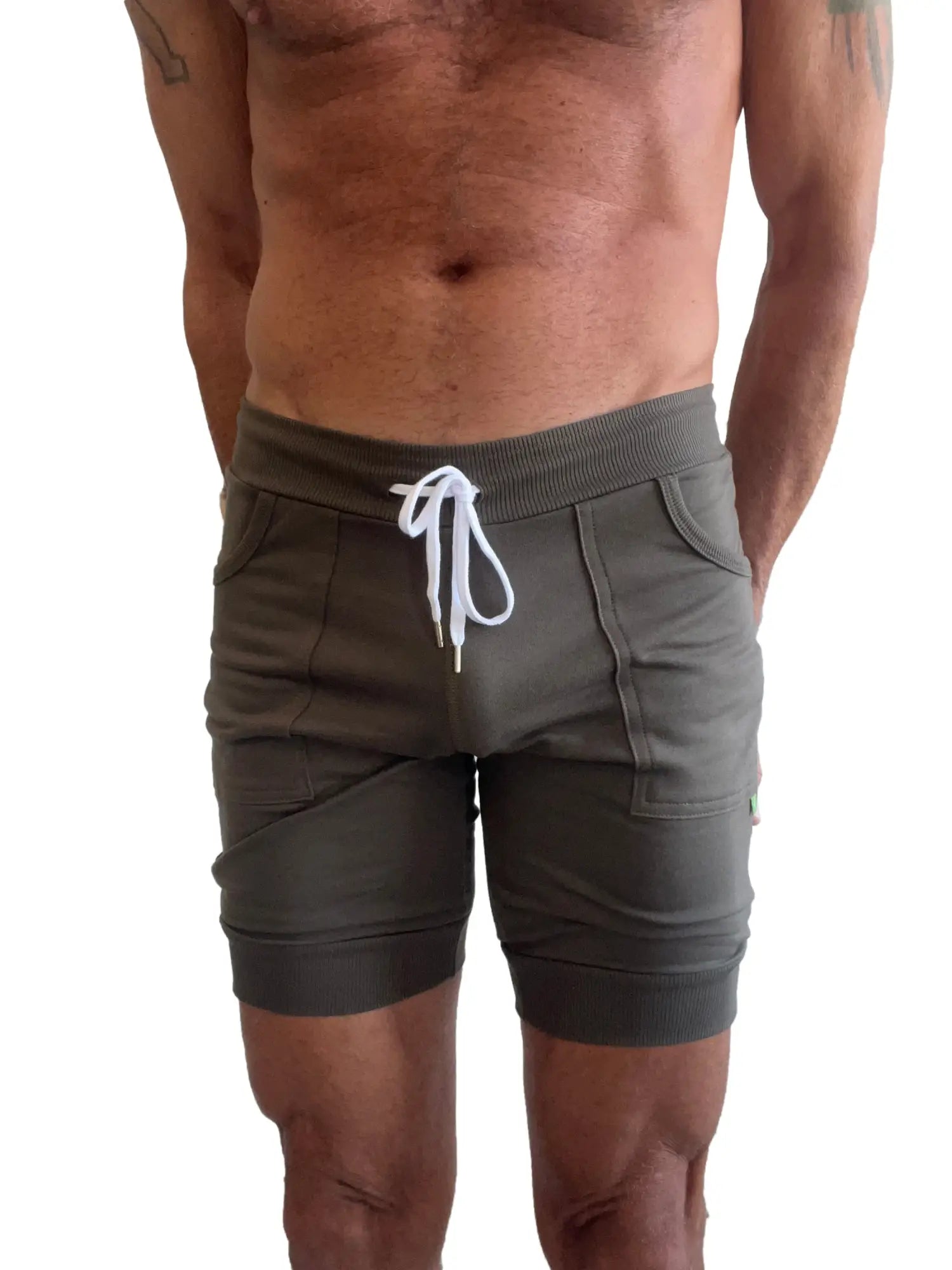 Olive green cuffed yoga shorts with ribbed waistband and white drawstring made for athletic wear
