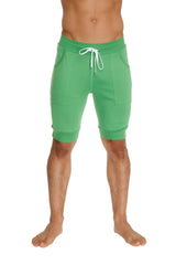 Green cuffed yoga shorts made of bamboo fabric with white drawstring and side pockets for athletic use