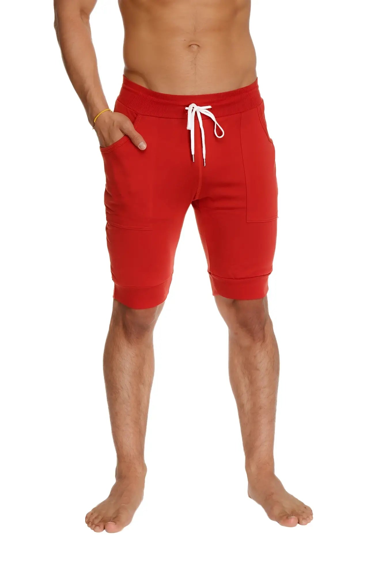 Red cuffed yoga shorts with white drawstring and side pockets designed for athletic wear in cinnabar red