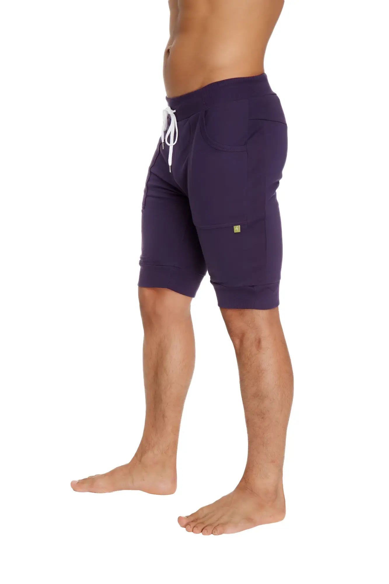 Purple cuffed yoga shorts with white drawstring and side pockets designed for athletic use