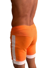 Bright orange cuffed yoga shorts with white ribbed side panels and cuffs for athletic wear