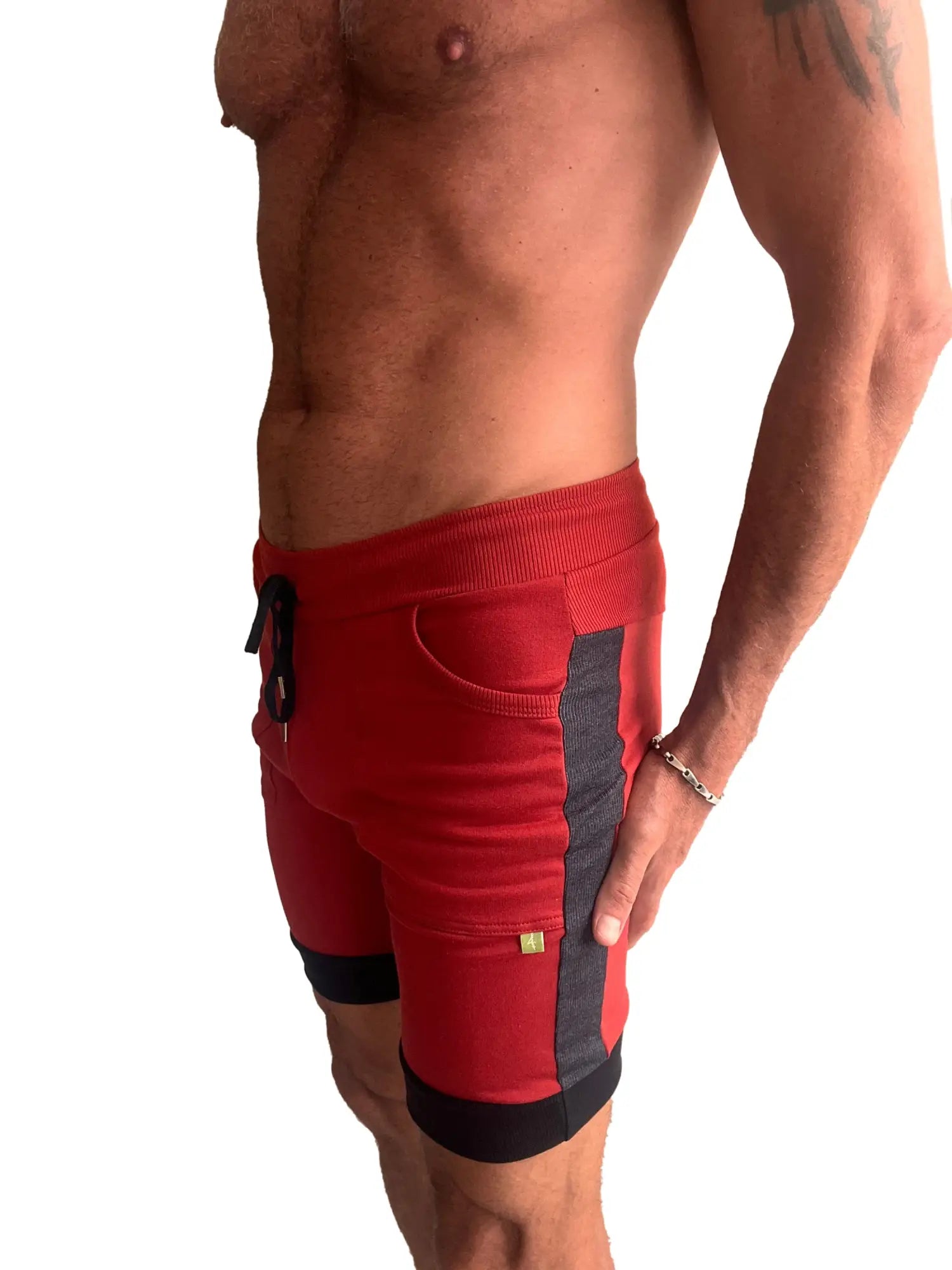 Red cuffed yoga shorts with ribbed waistband and black charcoal side panels for athletic wear