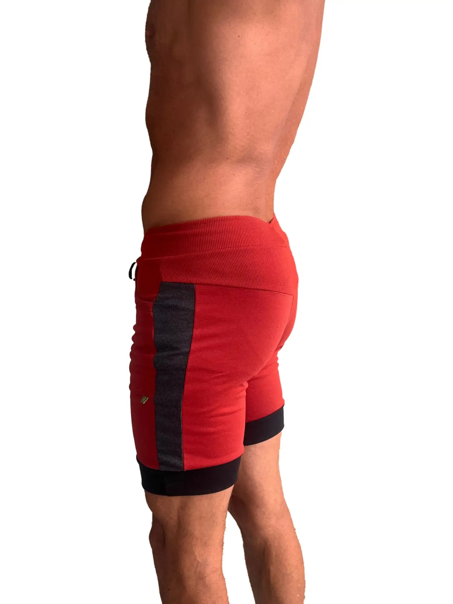 Red cuffed yoga shorts with charcoal and black panels featuring a ribbed waistband for athletic use