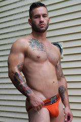 Orange textured briefs with black trim and branded waistband label from cumdump jock collection