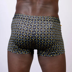 Black designer buckle print sq cut swim trunks with bold yellow and blue chain-link pattern for swimming and beachwear