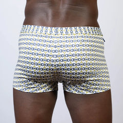 White designer buckle print square cut swim trunks with navy blue and yellow interlocking d-shape patterns