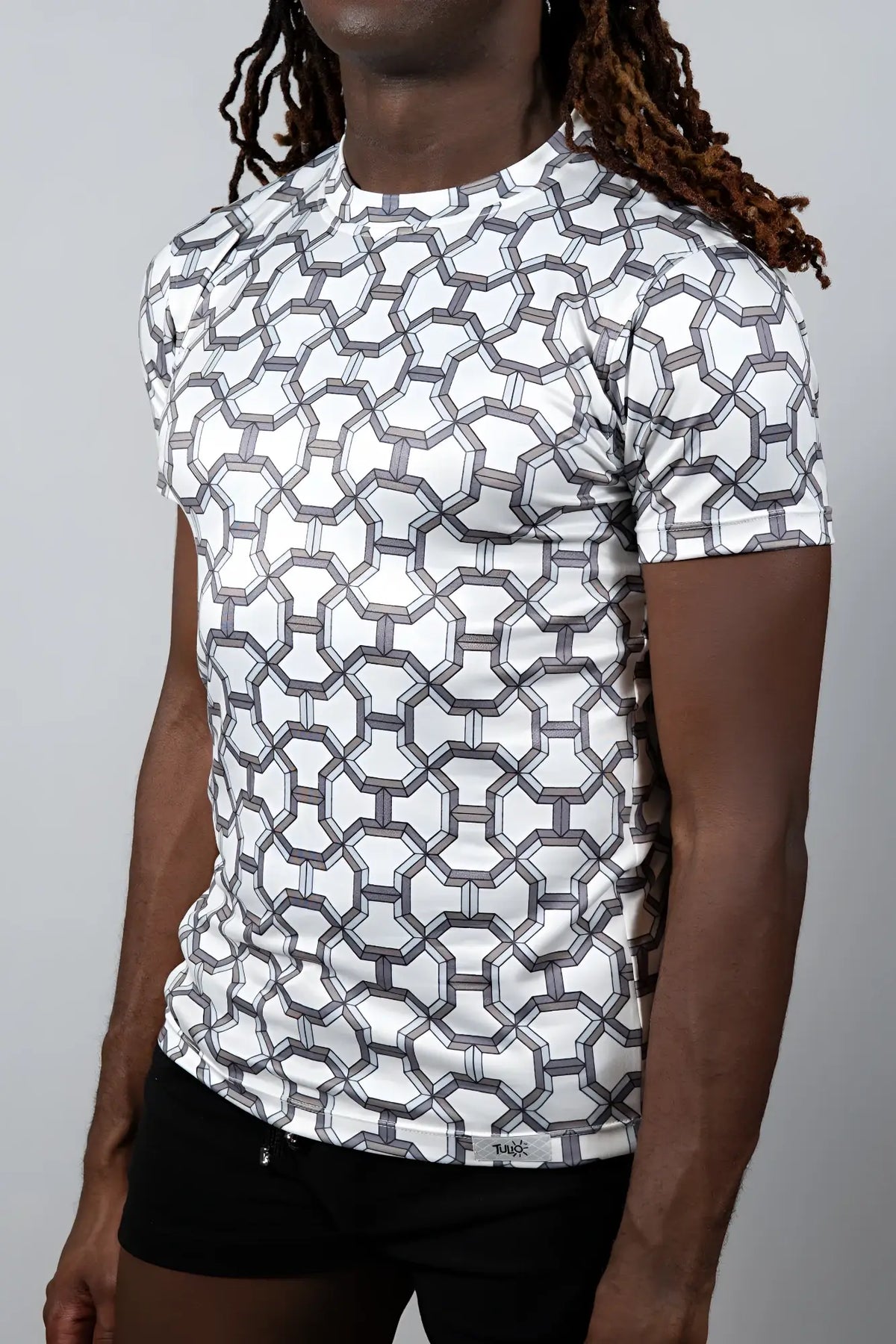 White short-sleeved rash guard with geometric gray pattern from designer inspired print tee collection