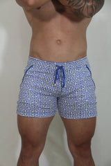 Designer print linen texture shorts featuring blue and white geometric patterned swim trunks with a matching drawstring waistband