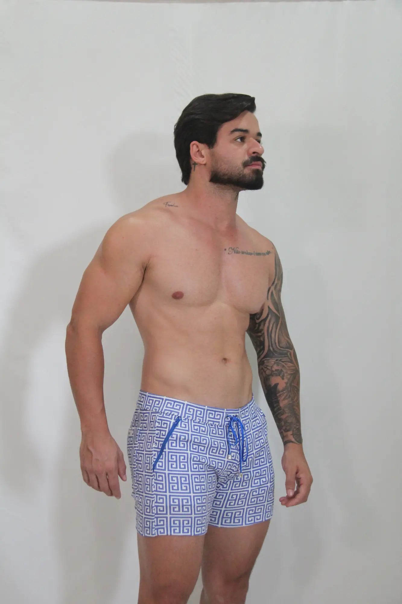 Designer print linen texture shorts in blue and white geometric pattern with matching drawstring for swimwear use