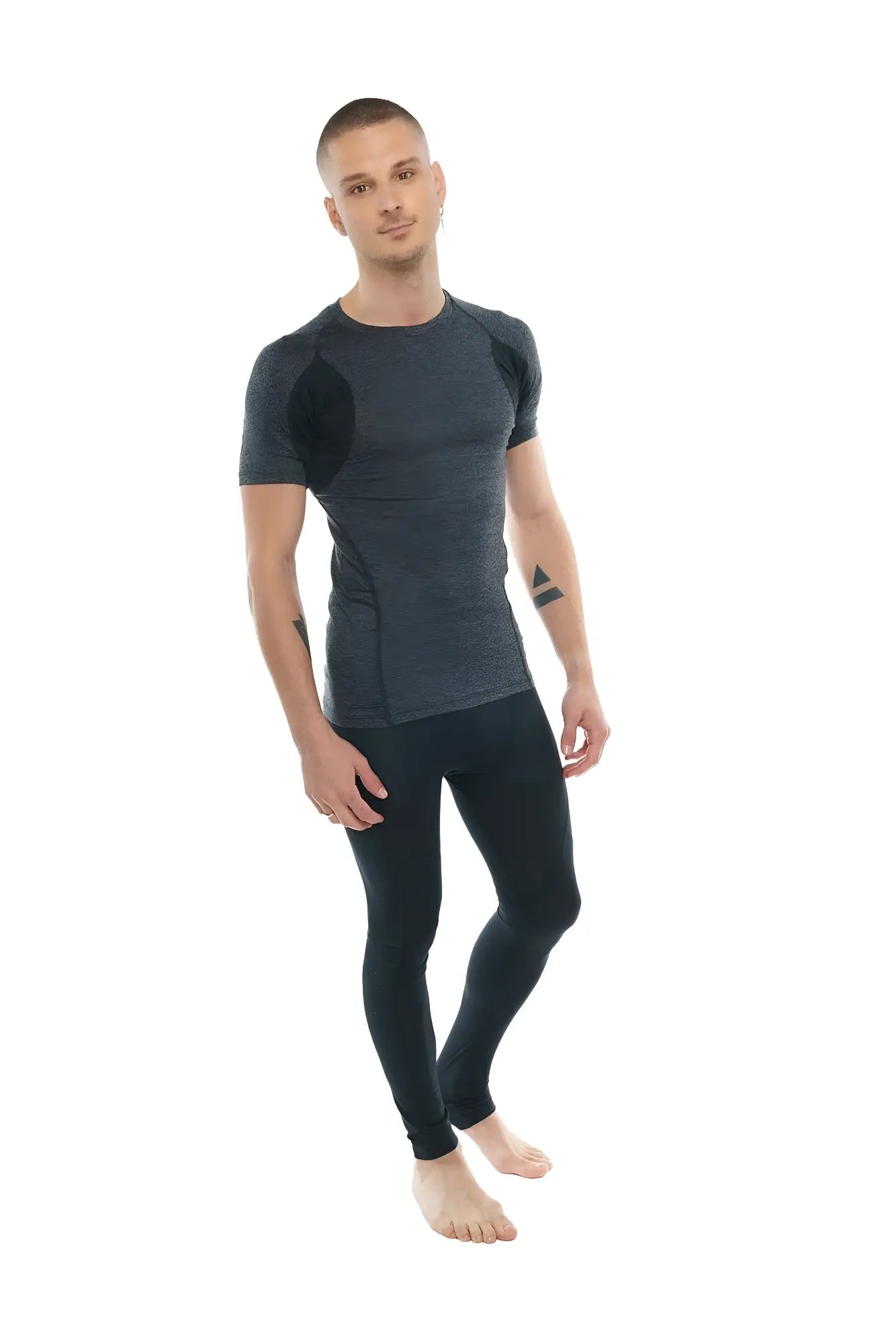 Dark gray and black designer raglan crew-neck tee with textured fabric panels paired with fitted performance leggings